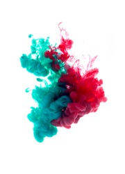 Colors dropped into liquid and photographed while in motion. Cloud of silky ink in water on white isolated background, an abstract banner.
