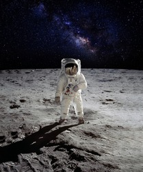 An astronaut walking on the surface of the moon with earth on lunar landing space mission. Elements of this image furnished by NASA.