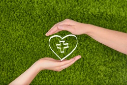 Two Woman's open hands making a protection gesture  isolated on green background.Family health, charity and medicine concept.