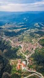 Panoramic aerial view of a small village nestled among the slopes of Rhodopi mountains, St.Petka village, Bulgaria	