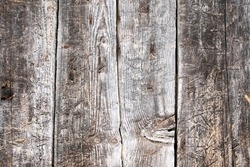 Old barn planks with knots and nails -- weathered wooden background