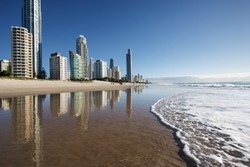 Reflection of apartments in sea at sunrise, Gold Coast, Australia