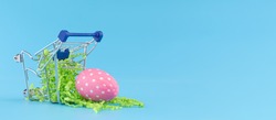 Pink Easter egg in shopping cart for Easter shopping concept.