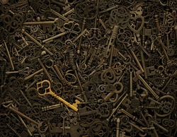 Unique gold key on pile of vintage skeleton keys. Concept for individual or uniqueness, unlocking potential, or stand out from the crowd.