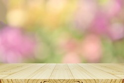 Perspective wood counter and abstract background with bokeh in pastel tone for spring, summer and blooming seasons.