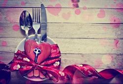 Valentines day table setting with plate, knife, fork, red ribbon and hearts/ Holidays background/ Valentines day background