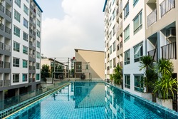 Swimming pool among high rise condo buildings, condominium with pool