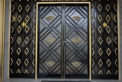 
Old black and gold art-deco door. Frontage on street.
