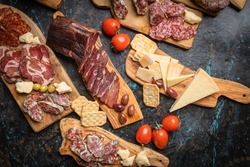 Charcuterie board with various cured meats and sausages