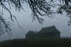Landscape with alone old house on foggy meadow. Can be used like Halloween background. Located place: Carpathians, Europe