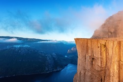 Misty morning on Preikestolen (pulpit-rock) - famous tourist attraction in the municipality of Forsand in Rogaland county, Norway. Landscape photography