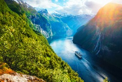 Breathtaking norway view of Sunnylvsfjorden fjord with cruise ship and famous Seven Sisters waterfalls, near Geiranger village in western Norway. Landscape photography