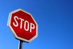 Stop sign on blue sky