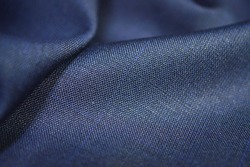 close up texture blue fabric of suit, photo shoot by depth of field for object