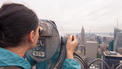 public telescope pointed on Manhattan buildings