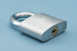 Locked Silver Padlock on a blue background.