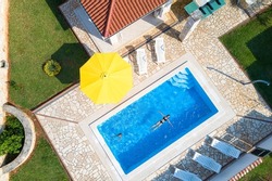 Croatia, Istria, Pula, mother and daughter swimming at the pool, birds eye view