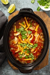 Slow cooker chicken taco soup topped with fresh cilantro