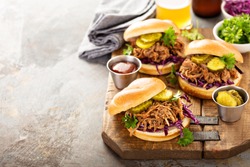 Pulled pork sandwiches with BBQ sauce, cabbage and pickles