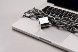 Close-up of laptop with a chain over it