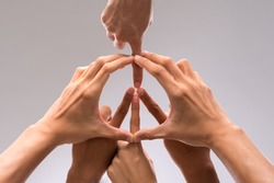 Hands of people forming a symbol of peace