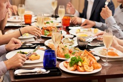 Dishes with various seafood at dinner table, selective focus