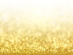 Gold Festive Christmas background. Abstract twinkled bright background with bokeh defocused golden lights