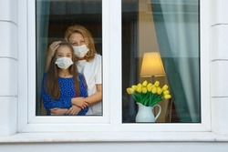 Mother and Daughter looking out for the quarantine to finish as soon as possible