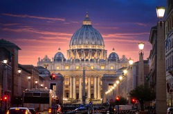 Saint Peter Basilica in Vatican City at Rome, Italy and Street Via della Conciliazione with a beautiful sunset sky.