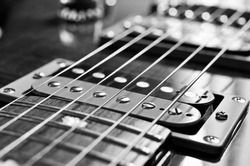 Detail of six-string electric guitar closeup, selective focus.Processed with vintage style.