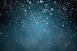Snowfall with Blue Background - Fluffy snowflakes falling in front of a blue background with vignette