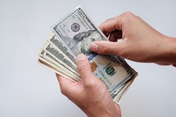 Hand holing American dollars banknotes on white background