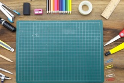Business concept:stapler,glue,scissor,cutter,tape,pen,pencil,clip,ruler,rubber, cutting mat,divider,sharpener and color pencil on wooden background.Top view