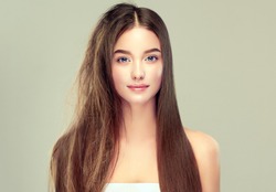 Hair care . Keratin straightening ,smoothing and treatment of the hair .  Girl with straight and smooth hair on one side of the head . The second side of the head tangled and un brushed hair . 