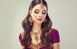 Portrait of beautiful indian girl. Young India woman model with kundan jewelry set. Traditional Indian costume lehenga choli or sari