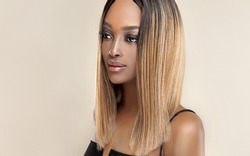 Beautiful African American woman with dyed and straight hair. The beauty of an afro black girl with a bob smooth hairstyle and toning. Keratin straightening. Treatment, care and spa procedures.