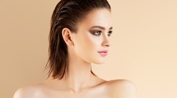 Beautiful young Woman  with wet hair effect  and clean fresh skin  .Girl  beauty face care. Facial  treatment   .