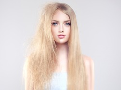 Hair care . Straightening ,smoothing and treatment of the hair .  Girl with straight and smooth hair on one side of the head . The second side of the head tangled and unbrushed hair .