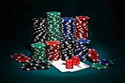 chips for poker with pair of aces and dice