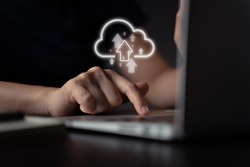 Woman using laptop for upload with cloud icon hologram effect.