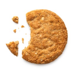Partially eaten crunchy oat and wholemeal biscuit with crumbs isolated on white. Top view.