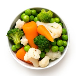 Mixed vegetables in white ceramic bowl isolated on white. Top view.
