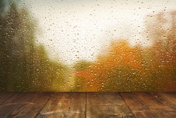 Table on rainy window background