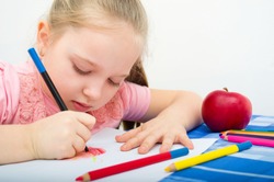 Closeup portrait of girl drawing with colorful pencils