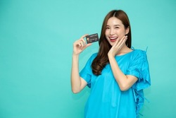 Young Asian beautiful woman patient showing credit card isolated on green background, Insurance card concept