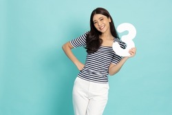 Young Asian woman showing number 3 or three isolated on green background