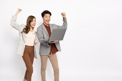 Asian businessman and businesswoman looking at laptop computer and hands up raised arms from happiness isolated on white background, Feeling happiness and winner success