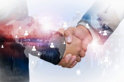 Double exposure of businessman handshake on industrial business background, connections concept, Elements of this image furnished by NASA.