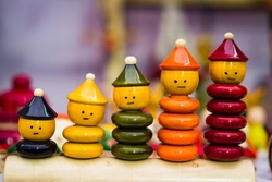colourful ring toy stacking doll figures with increasing sizes. channapatna toy