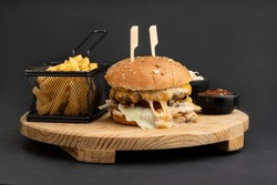 cheeseburger with melted cheddar cheese, caramelized onion, fresh mushroom, and gravy sauce served with fries and ketchup 